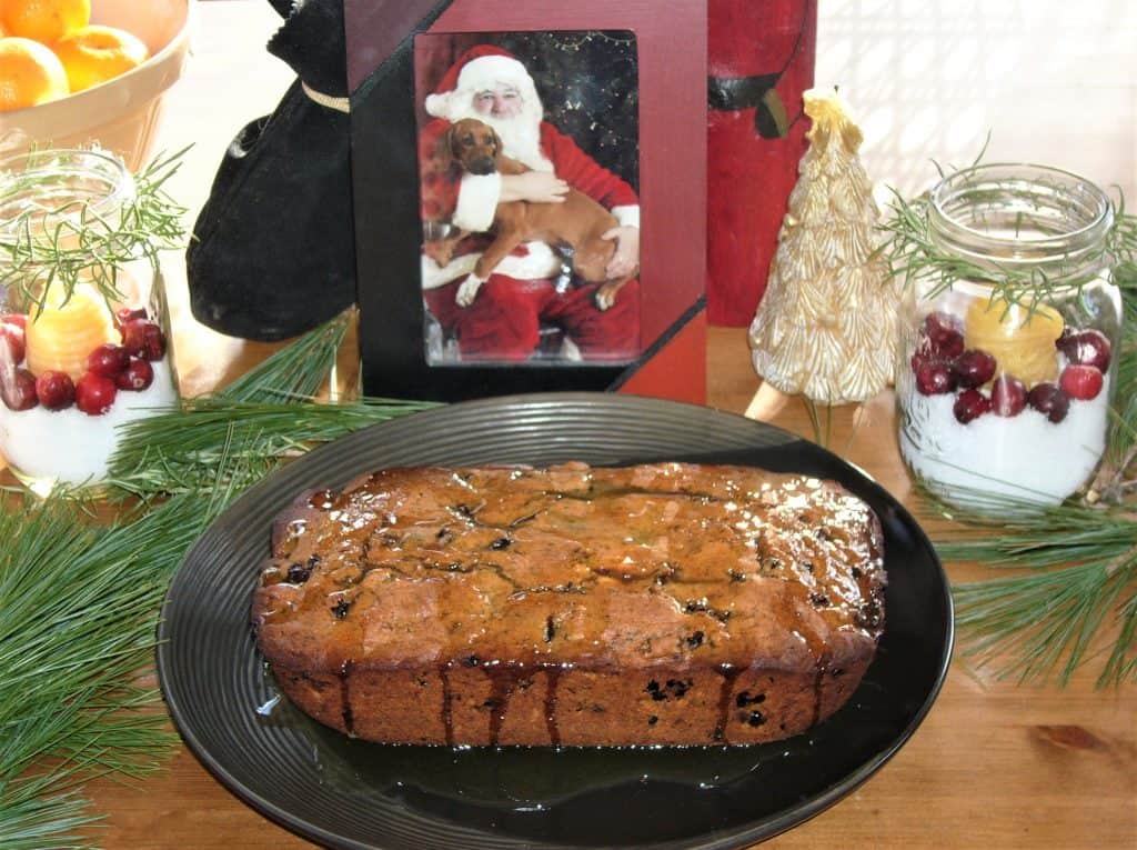 Image of a Christmas Conifer Cake in front of picture of Santa