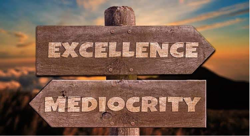 Picture of a sign showing two directions to go ... towards mediocrity or towards excellence.