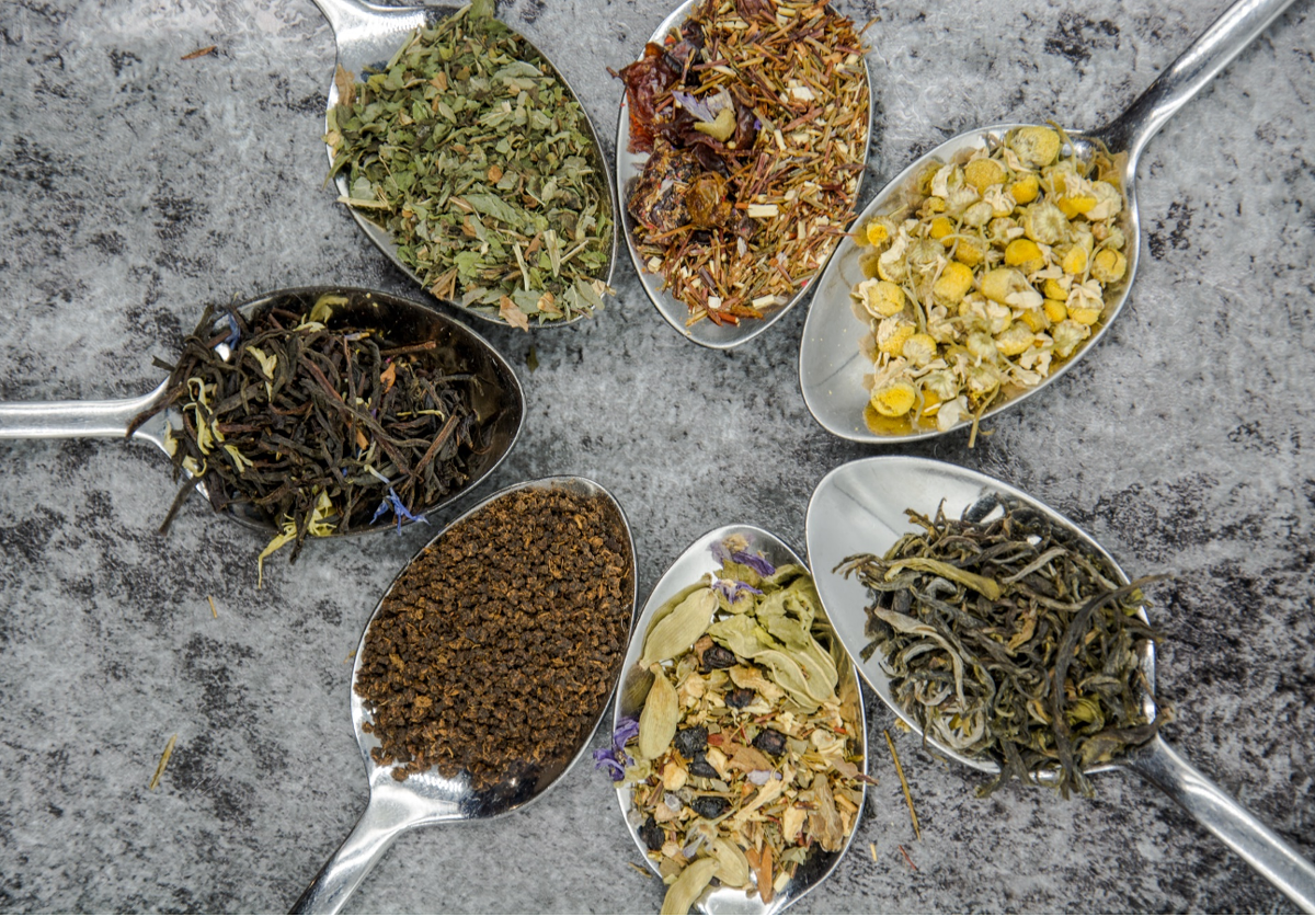 pic of spoons of various herbs arranged in a circle on a tabletop